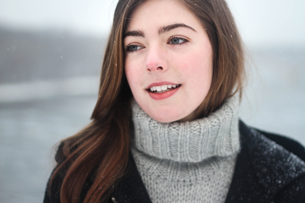 Woman who appears to have a stuffy nose, on a winter's snowy day